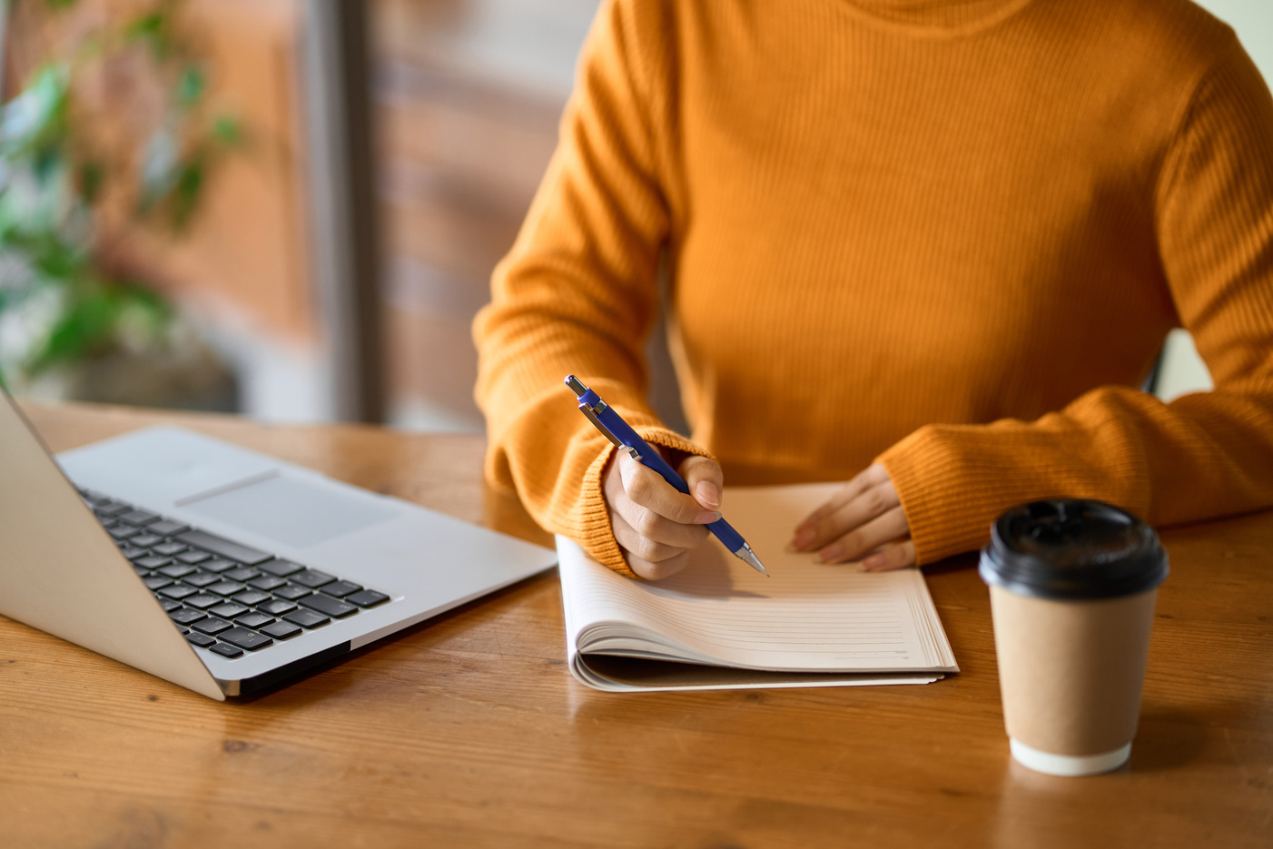 Asian woman's hand studying for qualifications